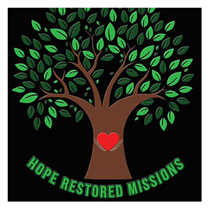 Logo for Hope Restored Missions featuring a tree with green leaves and a red heart at its center.